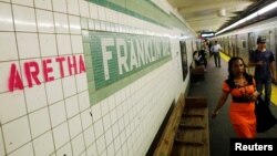 "Aretha" is spray painted next to a sign at the Franklin Street subway station, in memory of singer Aretha Franklin, in the Brooklyn borough of New York, Aug. 16, 2018. 