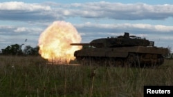 FILE - Ukrainian servicemen of the 21st Separate Mechanized Brigade fire a Leopard 2A6 tank during a military exercise, near a front line in Donetsk region, Ukraine, May 12, 2024. 