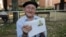 Maximino San Miguel, 102, holds a picture of himself when he was young as he poses for a portrait in a park near his home in Leon, northern Spain, Sept. 3, 2016
