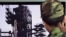 South Korean Army soldiers watch a TV news program which shows North Korea's Unha-3 rocket at Seoul train station in Seoul, South Korea, April 9, 2012
