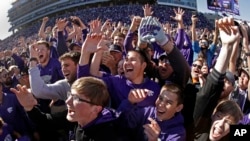 FILE - Kansas State fans cheer on the field after an NCAA college football game against Oklahoma in Manhattan, Kan., in this Saturday, Oct. 26, 2019, file photo.