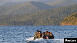 Philippine marines get transported from a patrol ship after conducting a mission near the Spratly Islands in the South China Sea on March 31, 2014. 