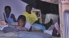 Haitian family sleeping outside after earthquake