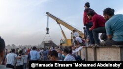 Onlookers are seen at the scene of a train accident north of Cairo, April 18, 2021. An increasing number of deadly rail accidents in recent years in Egypt have been blamed on poor maintenance and infrastructure. (Hamada Elrasam/VOA)