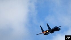 FILE - A F-15C Eagle jet fighter flies over Vilnius during a Lithuanian - NATO air force exercise in Lithuania, April 2, 2014. 