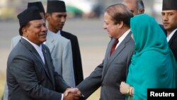 FILE - Nepali Deputy Prime Minister Prakash Man Singh (L) shakes hands with Pakistani Prime Minister Nawaz Sharif upon his arrival for the 18th South Asian Association for Regional Cooperation (SAARC) summit in Kathmandu, Nov. 25, 2014.