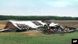 In this image made from video provided by WLBT-TV strong storms pound parts of the Deep South, including this house and shed in Yazoo County, Miss., Sunday, April 12, 2020. 