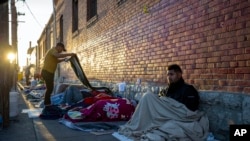 FILE—Migrants wake up at a campsite outside Sacred Heart Church in downtown El Paso, Tuesday morning, May 9, 2023.