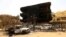 Damaged cars and buildings are seen at the central market in Khartoum North