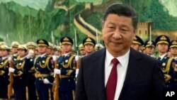 FILE - Chinese President Xi Jinping reviews a Chinese honor guard during a welcome ceremony for a visiting dignitary at the Great Hall of the People in Beijing, Jan. 9, 2018.