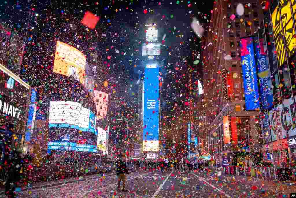 Confetti flies after the Times Square New Year&#39;s Eve Ball drops in a nearly empty Times Square, as the area normally packed with revelers remained closed off due to the ongoing coronavirus pandemic.