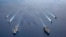In this photo provided by U.S. Navy, the USS Ronald Reagan (CVN 76) and USS Nimitz (CVN 68) Carrier Strike Groups steam in formation, in the South China Sea, Monday, July 6, 2020. China on Monday, July 6, accused the U.S. of flexing its military…