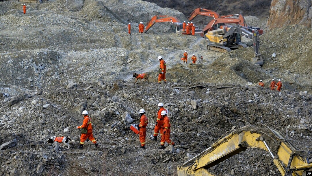 In this photo taken Saturday, Mar. 30, 2013, rescuers search through rocks and debris at a gold mine after a mudslide in Gyama village, in Maizhokunggar County of Lhasa, Tibet.