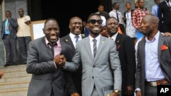 FILE - Ugandan pop star Kyagulanyi Ssentamu, better known as Bobi Wine, center, leaves shortly after being sworn in as a member of parliament in Kampala, Uganda, July 11, 2017.