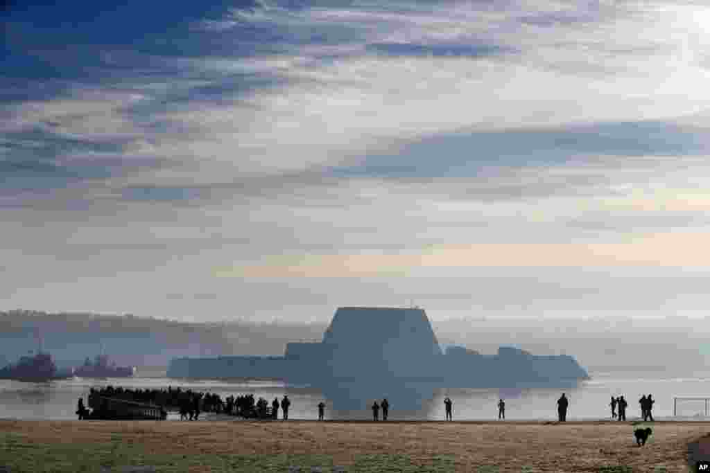 The first Zumwalt-class destroyer, the largest ever built for the U.S. Navy, heads down the Kennebec River after leaving Bath Iron Works in Bath, Maine. The ship is headed out to sea for the first time to undergo sea trials.