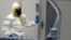 A firefighter dressed in protective suit walks into government mail screening facility outside Washington, DC April 17, 2013