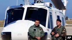 Lebanese army soldiers stand guard in front of a military Huey II helicopter during a ceremony at the Rafik Hariri International Airport in Beirut, Lebanon, March 31, 2016. 