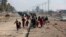 Displaced Iraqis, who fled fighting between Iraqi security forces and Islamic State militants, return to their homes in neighborhoods retaken by Iraqi government forces in the eastern side of Mosul, Iraq, Jan. 4, 2017. 