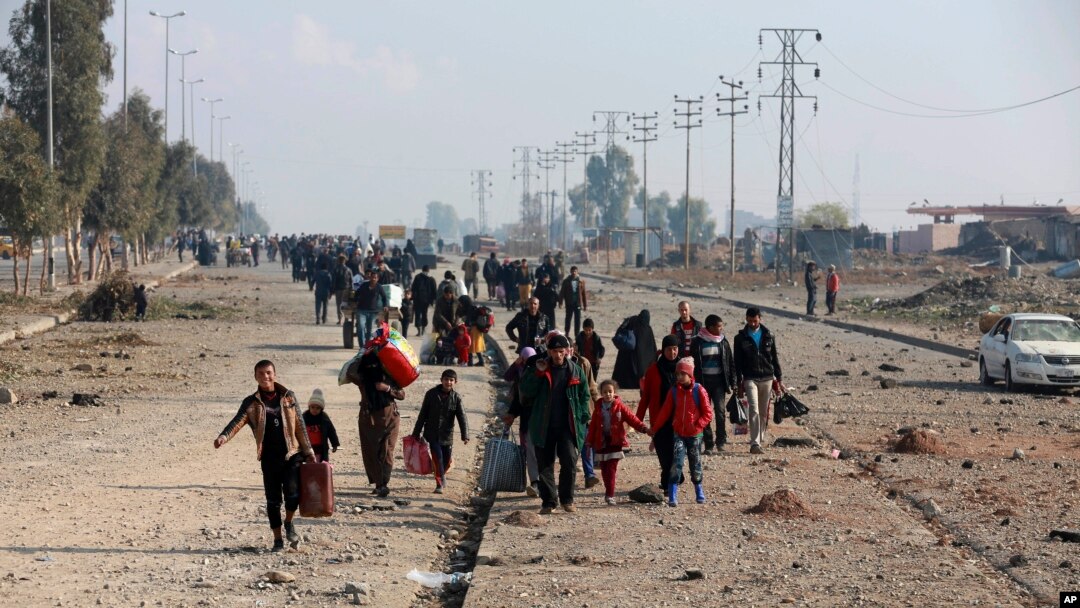 Displaced Iraqis, who fled fighting between Iraqi security forces and Islamic State militants, return to their homes in neighborhoods retaken by Iraqi government forces in the eastern side of Mosul, Iraq, Wednesday, Jan. 4, 2017. 