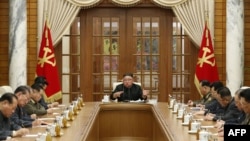 This picture taken on November 29, 2020 and released from North Korea's official Korean Central News Agency (KCNA) on November 30, 2020 shows North Korean leader Kim Jong Un (C) attending a meeting of the 21st Political Bureau of the 7th Central…