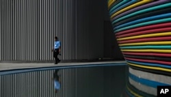 A man walks through the venue for the COP28 UN Climate Change Conference in Dubai, United Arab Emirates, Nov. 30, 2023.