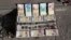 Iranian banknotes and foreign coins are displayed by a vendor on a Ferdowsi Street sidewalk in Tehran, Jan. 23, 2013.