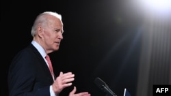 (FILES) In this file photo taken on March 12, 2020 former US Vice President and Democratic presidential hopeful Joe Biden speaks about COVID-19, known as the Coronavirus, during a press event in Wilmington, Delaware. - Former Vice President Joe…