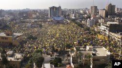 Tens of thousands of Palestinians marched Friday carrying yellow banners of Palestinian President Mahmoud Abbas' Fatah party during celebrations marking the 48th anniversary of the Fatah movement in Gaza City, January 4, 2013.