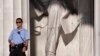 A U.S. Park Police officer stands guard next to the statue of Abraham Lincoln at the memorial in Washington, July 26, 2013