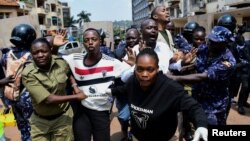 Ugandan police officers detain protestors during a rally against what the protesters say are rampant corruption and human rights abuses by the country's rulers in Kampala, Uganda, July 23, 2024. 