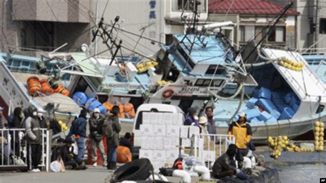 Local residents wait for a ship to travel to a nearby island from the devastated city of Kesennuma, northeastern Japan, just one week after a massive earthquake and resulting tsunami, March 18, 2011