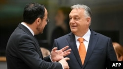 Hungary's Prime Minister Viktor Orban, right, speaks with Cyprus' President Nikos Christodoulides ahead of the Special European Council to discuss continued support for Ukraine and European defense at the EU headquarters in Brussels on March 6, 2025.