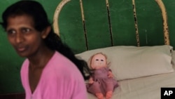 Resident of Half Way Home, a government-run home for the mentally ill located inside a mental health hospital premise, sits on her bed in Mulleriyawa, on the outskirts of Colombo, Sri Lanka, April 2, 2013.