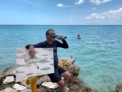 Cuban artist Sandor Gonzalez speaks to the media after painting underwater in Punta Perdiz, June 18, 2019