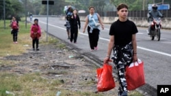 Migrants walk through Tapachula, Chiapas state, Mexico, Jan. 2, 2025, as part of a caravan trying to reach the U.S. border.