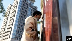 A man gets swabbed for COVID test near a building of the Peking University in Beijing, Wednesday, Nov. 16, 2022. 