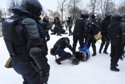 Police detain protesters during a rally in support of jailed opposition leader Alexei Navalny in Saint Petersburg, Jan. 31, 2021.