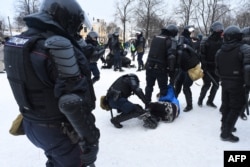 Police detain protesters during a rally in support of jailed opposition leader Alexei Navalny in Saint Petersburg, Jan. 31, 2021.