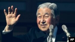 FILE - Japan's Emperor Akihito waves to well-wishers as he appears on the bulletproofed balcony of the Imperial Palace in Tokyo, Dec. 23, 2017. That was on his 84th birthday; he turns 85 Sunday.