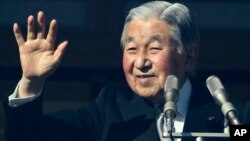 Japan's Emperor Akihito waves to well-wishers as he appears on the bullet-proofed balcony of the Imperial Palace in Tokyo, Dec. 23, 2017.