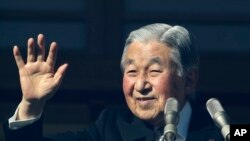 Kaisar Jepang Akihito melambaikan tangan kepada masyarakat dari balkon tahan peluru di Istana Kekaisaran di Tokyo, 23 Desember 2017.