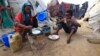 An internally displaced Somali girl prepares the traditional Somali breakfast "Anjero" at Sayyidka camp in the Howlwadag district, south of Somalia's capital Mogadishu, May 3, 2013. 