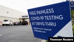 Vehicles line up at a self-swabbing coronavirus disease (COVID-19) test at a Rite Aid drive-thru during the outbreak of COVID-19, in Pasadena, Jan. 25, 2021.