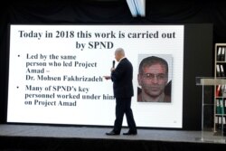 FILE - Israeli Prime Minister Benjamin Netanyahu points at a screen with an image of Iranian nuclear scientist Mohsen Fakhrizadeh during a news conference at the Ministry of Defence in Tel Aviv, April 30, 2018.