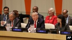 FILE - U.S. President Donald Trump, center, speaks while United Nations Secretary-General Antonio Guterres, left, and U.S. Ambassador to the United Nations Nikki Haley look on, at U.N. headquarters, Sept. 18, 2017.