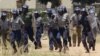 FILE: Police leave a scene after throwing teargas at a house in Chitungwiza, Zimbabwe, Sunday, Nov. 6, 2011. 