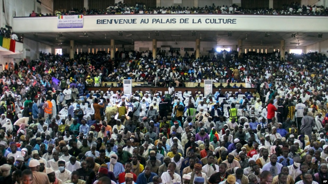 People attend a prayer service led by Mahmoud Dicko, an imam who helped lead the opposition protests, for those who died or were injured during the protests, in Bamako, Mali, Aug. 28, 2020. 