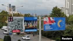 FILE - A drone view shows election billboards of the ruling Georgian Dream party, one of which depicts a Ukrainian city ruined by Russia's war contrasted against a peaceful Georgian one, in Tbilisi, Georgia, Sept. 27, 2024.