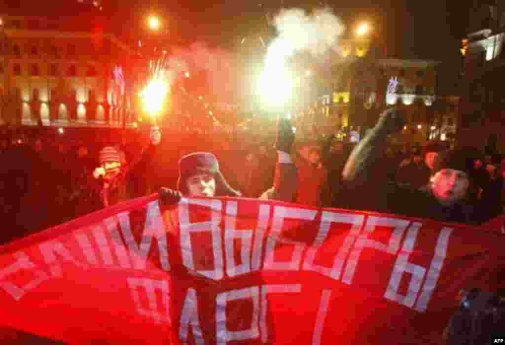 Opposition protesters light flares and shout slogans as they rally in downtown Minsk, Berlarus, Sunday, Dec. 19, 2010. Belarus' authoritarian leader Alexander Lukashenko, a frequent antagonist of both Russia and the West, seeks a fourth term in Sunday ele