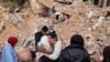 Displaced residents hug as they stand in front of the rubble of their destroyed house in Baalbek, eastern Lebanon, Nov. 28, 2024. 